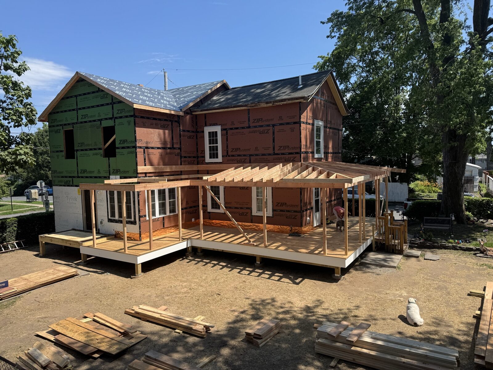 Second-story deck and porch addition under construction on a renovated home